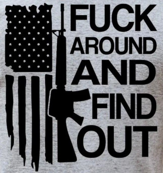 T-shirt with American flag graphic and text 'F*ck around and find out' on a gray background