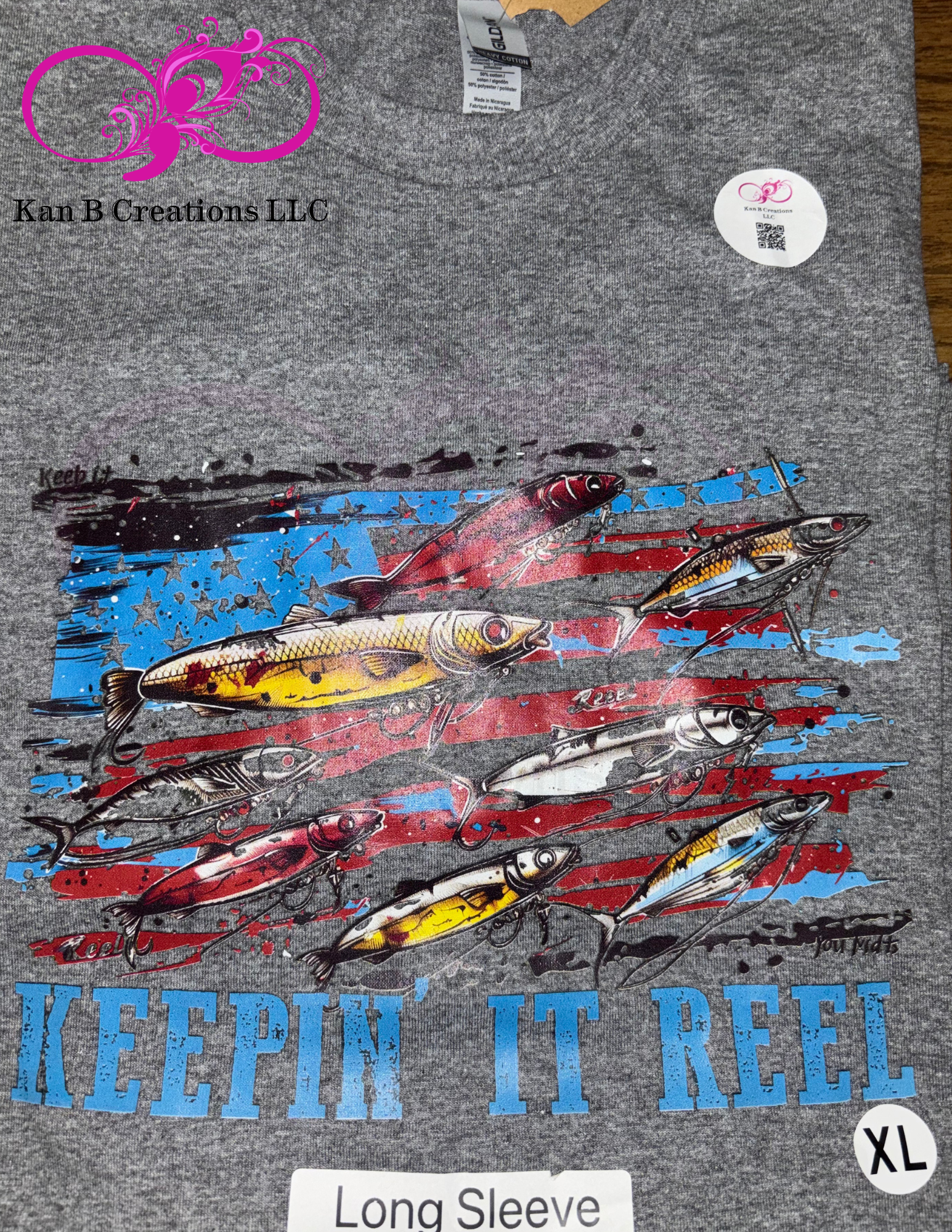 Gray long-sleeve shirt with fishing lure graphic and 'Keepin' It Reel' text.